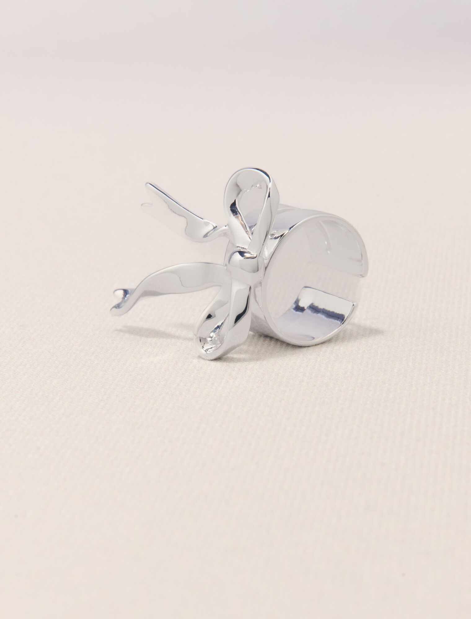 Open silver bow ring